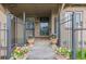 Welcoming covered front porch with potted flowers, and secure fencing at 1090 E 3Rd Ave, Denver, CO 80218