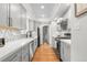Modern kitchen featuring gray cabinets, quartz countertops, stainless steel appliances and wood floors at 1090 E 3Rd Ave, Denver, CO 80218