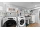 Functional laundry room with washer, dryer, sink, and storage cabinets, designed for efficient laundry tasks at 1090 E 3Rd Ave, Denver, CO 80218
