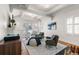 Bright living room boasts exposed beams, hardwood floors, and an abundance of natural light at 1090 E 3Rd Ave, Denver, CO 80218