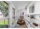 Cozy sunroom featuring large windows, a comfortable seating area, and built-in shelving at 1090 E 3Rd Ave, Denver, CO 80218