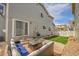Backyard patio with comfortable seating and a well-manicured lawn offering relaxation and outdoor enjoyment at 14332 Craftsman Way, Broomfield, CO 80023