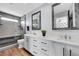 Modern bathroom features a double vanity with granite countertops, sleek mirrors, and a glass-enclosed shower at 14332 Craftsman Way, Broomfield, CO 80023