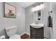 Charming powder room with fun art, stylish mirror, and modern fixtures, adding a touch of whimsy at 14332 Craftsman Way, Broomfield, CO 80023