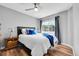 Bedroom features hardwood floors, a ceiling fan, and a comfortable bed with elegant blue accents at 14332 Craftsman Way, Broomfield, CO 80023