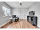 Spare room featuring hardwood floors, natural light, sitting chair, and entertainment center at 14332 Craftsman Way, Broomfield, CO 80023