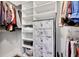 Organized walk-in closet featuring built-in shelving, hanging racks, and a decorative dresser at 14332 Craftsman Way, Broomfield, CO 80023