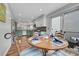 Cozy dining area features a wood table set for four, adjacent to the kitchen and sliding doors to the outside at 14332 Craftsman Way, Broomfield, CO 80023