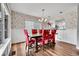 Elegant dining room with stylish wallpaper, a modern chandelier, and a wooden dining table at 14332 Craftsman Way, Broomfield, CO 80023