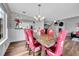 Elegant dining room with modern chandelier, a wooden dining table, and a view to the living room at 14332 Craftsman Way, Broomfield, CO 80023