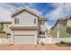 Charming two-story home boasts a two-car garage and well-maintained landscaping, under a bright sky at 14332 Craftsman Way, Broomfield, CO 80023