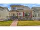 Charming two-story home showcasing a well-maintained lawn and inviting front entrance with stone accents at 14332 Craftsman Way, Broomfield, CO 80023