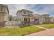 Inviting two-story home with landscaped front yard, sidewalk and a charming American flag on the porch at 14332 Craftsman Way, Broomfield, CO 80023