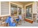 Cozy front porch featuring comfortable seating, stylish decor, and a welcoming entryway at 14332 Craftsman Way, Broomfield, CO 80023