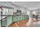 Spacious kitchen featuring sleek countertops, modern appliances, and hardwood floors at 14332 Craftsman Way, Broomfield, CO 80023