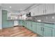 Open kitchen showcasing a modern backsplash, stylish cabinetry, and stainless steel appliances at 14332 Craftsman Way, Broomfield, CO 80023