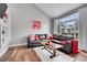 Well-lit living room with a large window, comfortable seating, and stylish decor at 14332 Craftsman Way, Broomfield, CO 80023