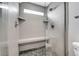 Contemporary walk-in shower with stylish tile, seating and glass door at 14332 Craftsman Way, Broomfield, CO 80023