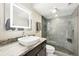 Modern bathroom with a glass walk-in shower, lighted mirror, vessel sink, and vanity at 2 Adams St # 705, Denver, CO 80206