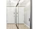 Hallway features mirrored closet doors and plank floors at 2 Adams St # 705, Denver, CO 80206