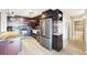 Updated kitchen features stainless steel appliances, dark wood cabinetry, and new flooring at 2 Adams St # 705, Denver, CO 80206
