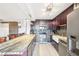 Modern kitchen with stainless steel appliances, granite countertops, and a breakfast bar with chairs at 2 Adams St # 705, Denver, CO 80206