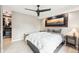 A calm main bedroom with neutral walls, a ceiling fan, a decorative picture frame, and closet access at 2 Adams St # 705, Denver, CO 80206