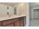 Bathroom featuring a double sink vanity with dark wood cabinets, white countertop, and modern fixtures at 15818 E Otero Cir, Centennial, CO 80112
