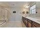 Bathroom featuring a double sink vanity, tiled floor, and glass shower doors at 15818 E Otero Cir, Centennial, CO 80112
