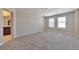 This spacious bedroom has large windows, carpet, and a doorway to the bathroom at 15818 E Otero Cir, Centennial, CO 80112