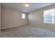 This bedroom features a soft carpet, large windows, and neutral walls at 15818 E Otero Cir, Centennial, CO 80112