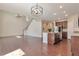 Open floor plan with hardwood floors, kitchen island, and staircase at 15818 E Otero Cir, Centennial, CO 80112