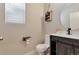 Well-appointed powder room with rustic wooden vanity and modern fixtures at 15818 E Otero Cir, Centennial, CO 80112