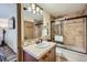 Bathroom featuring a tiled shower/tub, vanity with a tile countertop, and updated fixtures at 107 N Harris St # 111, Breckenridge, CO 80424