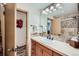 Bathroom with a single sink vanity with drawers, large mirror, and tiled shower behind at 107 N Harris St # 111, Breckenridge, CO 80424