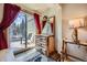 Cozy bedroom featuring rustic wood dresser, accent mirror, and sliding glass door to balcony at 107 N Harris St # 111, Breckenridge, CO 80424