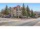 Multi-story condo building with mountain views and ample parking on a sunny day at 107 N Harris St # 111, Breckenridge, CO 80424