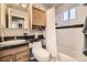 Cozy bathroom with a shower and tub combo, vanity, and a mirror at 5510 S Windermere St, Littleton, CO 80120