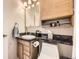 Updated bathroom with a vanity, toilet, mirror, and storage shelves at 5510 S Windermere St, Littleton, CO 80120