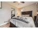 Serene bedroom with hardwood floors, a dark wood bed frame, and a view into the living room at 5510 S Windermere St, Littleton, CO 80120