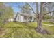 View of home's exterior with a well-maintained lawn, trees, and a brick pathway leading to the front entrance at 5510 S Windermere St, Littleton, CO 80120