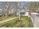 Home featuring well-kept lawn, trees, brick path leading to the entrance, and a chain-link fence at 5510 S Windermere St, Littleton, CO 80120