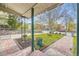 View from the porch showcasing the landscaped front yard, trees, and surrounding neighborhood at 5510 S Windermere St, Littleton, CO 80120