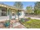 Close-up of the home's porch and front entrance with decorative green trim and well-kept landscaping at 5510 S Windermere St, Littleton, CO 80120