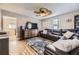 Living room with hardwood floors, large leather sofa, ceiling fan, and entertainment center at 5510 S Windermere St, Littleton, CO 80120