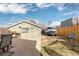 Spacious backyard featuring a green garage, a hammock, a patio seating area, and privacy fencing at 3942 Alcott St, Denver, CO 80211