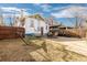 Spacious backyard with a patio area, perfect for outdoor dining and relaxation, surrounded by a wooden fence at 3942 Alcott St, Denver, CO 80211