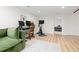 Open basement area with a green sectional, desk and workout equipment at 3942 Alcott St, Denver, CO 80211