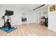 Finished basement featuring light wood floors, an exercise area, and a bar area with a beverage fridge at 3942 Alcott St, Denver, CO 80211