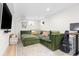 Basement living area with a green sectional and plenty of natural light at 3942 Alcott St, Denver, CO 80211
